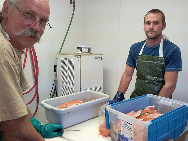 Ted and Noah filleting trout
